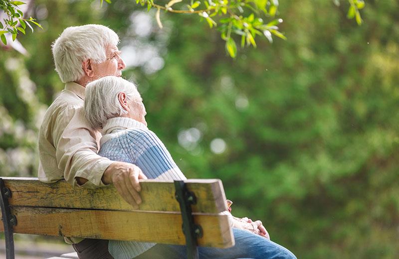 Elderly couple on park bench